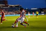 Jugador de Necaxa conduce el balon en el Estadio Victoria