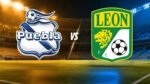 Escudos del Club Puebla y del León frente a frente en un estadio, con la palabra VS al centro.