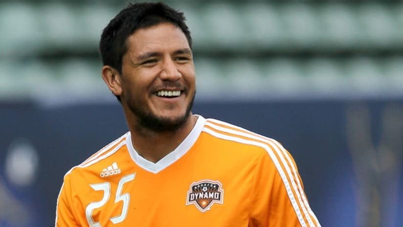 Brian Ching, con la camiseta naranja del Houston Dynamo y el número 25, sonríe durante un entrenamiento.