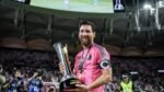 Lionel Messi sonríe con el trofeo de la Campeones Cup en las manos, con la playera rosa de Inter Miami y el brazalete de capitán.